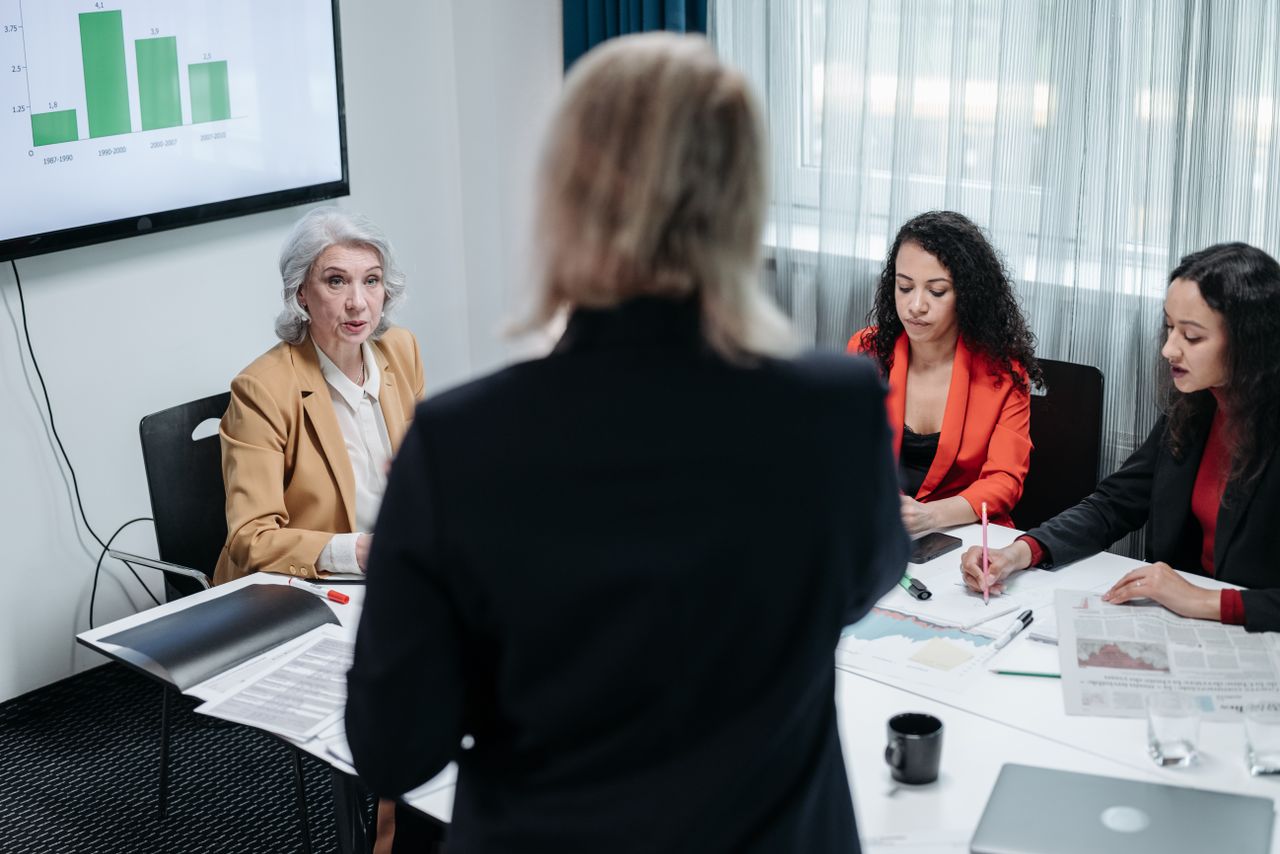about-01 Team of professionals discussing strategy in a modern office setting during a business meeting.